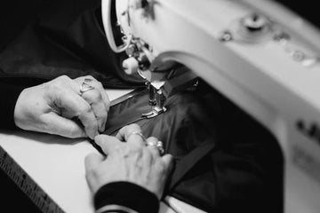 Person using a sewing machine with close-up of hands and fabric
