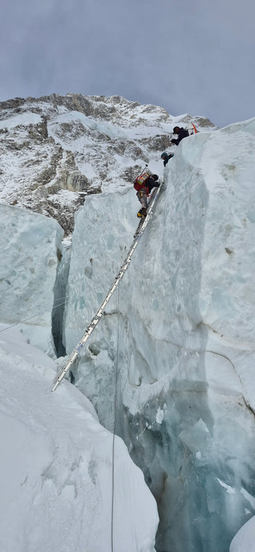 Two climbers on a steep ice wall with ropes and equipment. Rescue mission. Buffalo Systems