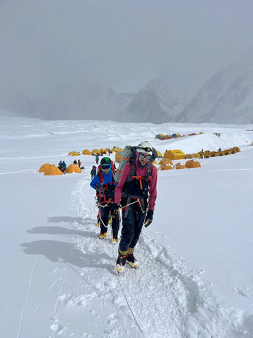 Two climbers on a snowy mountain on a mountain rescue mission wearing buffalo systems gear
