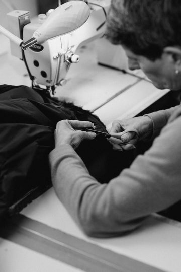 Person is cutting fabric with scissors