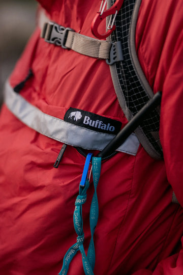 Red jacket with a visible Buffalo Systems logo on a blurred background