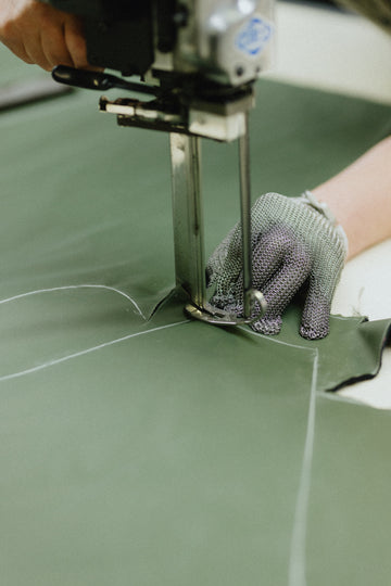 Person is cutting fabric with a cutting machine