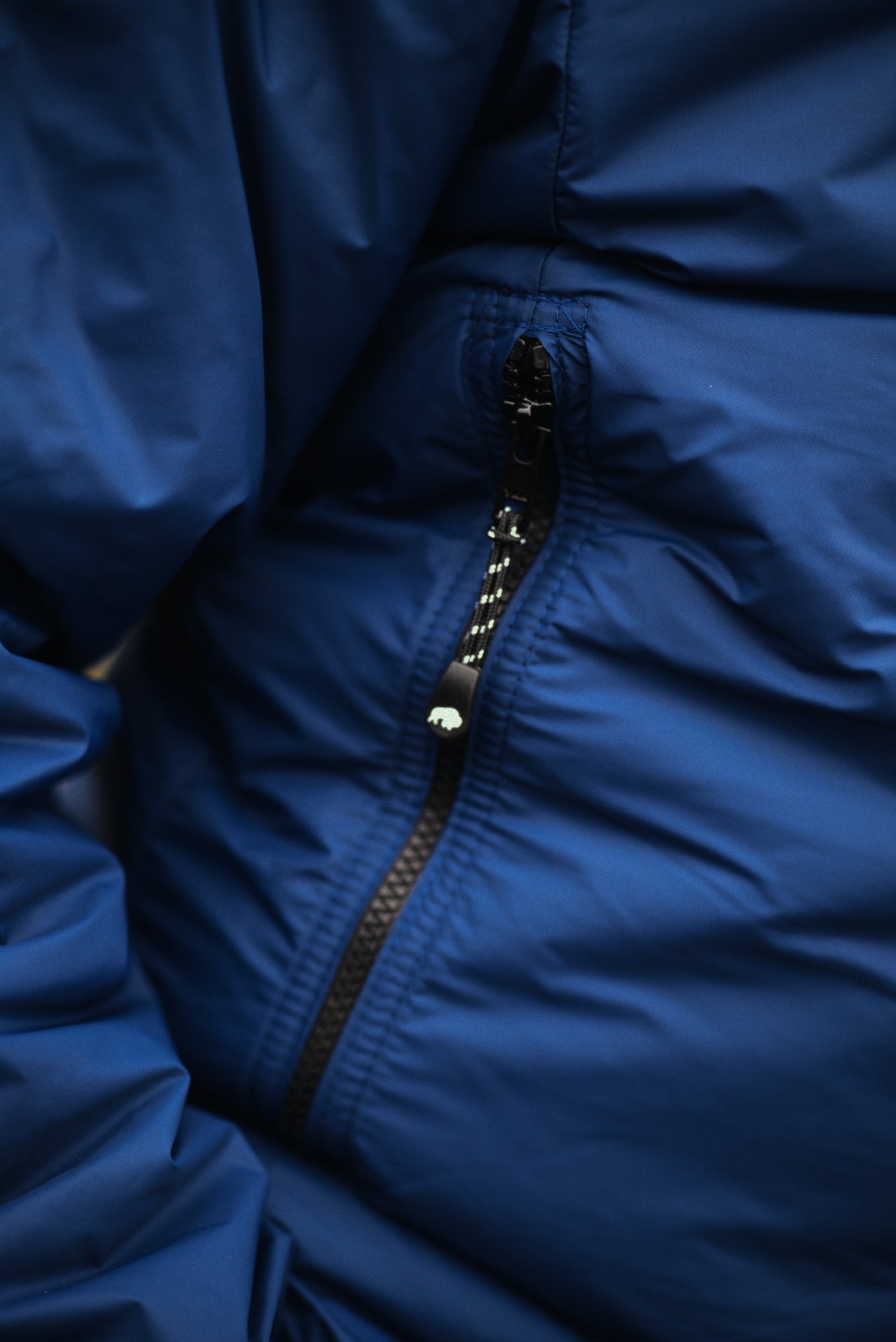 Close-up of a blue jacket with a zipper