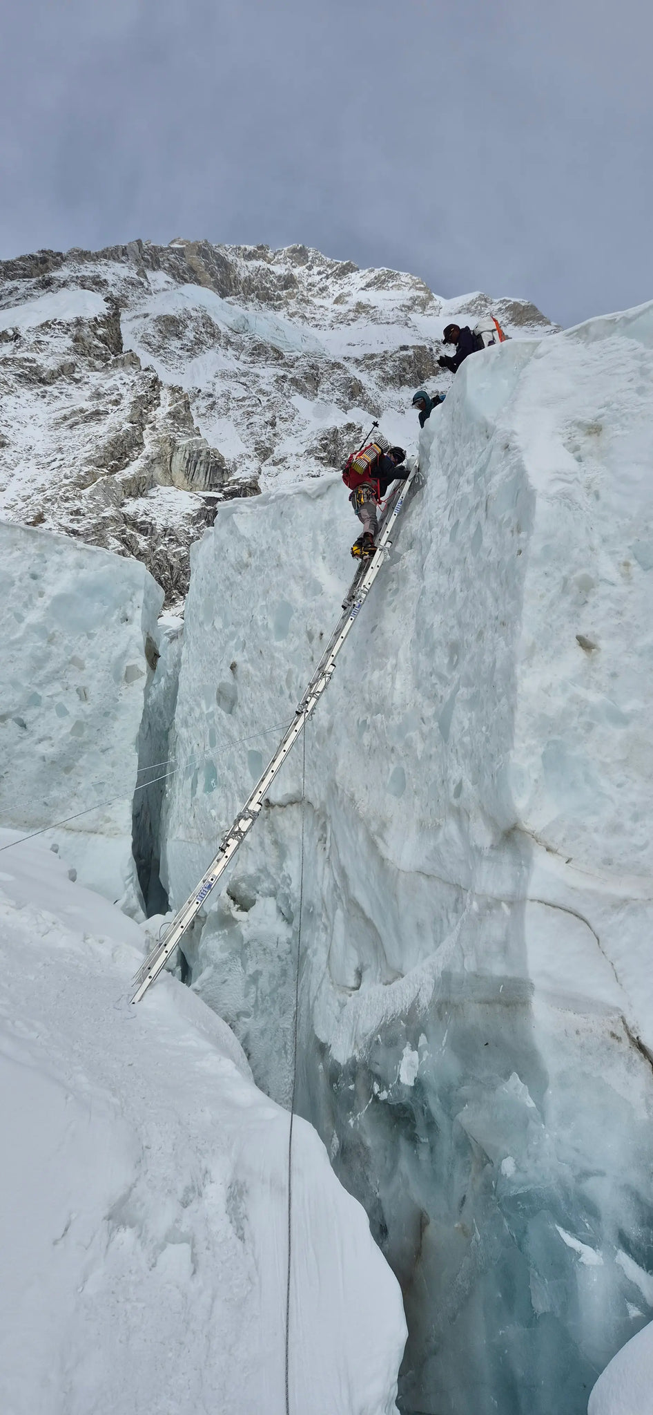 Two climbers on a steep ice wall with ropes and equipment. Rescue mission. Buffalo Systems